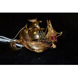 An 18ct gold brooch set with red stones in the form of a Galleon in full sail,