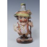 A Royal Crown Derby Mansion House dwarf, richly attired in 17th century cavalier costume,