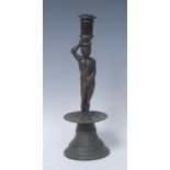 A 17th/18th century figural candlestick, of seamed construction, cylindrical sconce,
