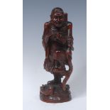 A Chinese boxwood figure, well carved as an elder with a dragon, a further beast at his feet, 24.