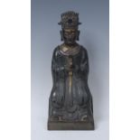 A Chinese gilt and polychrome painted bronze figure, of an elder, seated holding a sceptre,