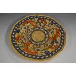 A Charlotte Rhead Crown Ducal shaped circular plate, tube lined with stylised orange flowerheads,