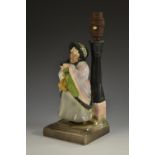 An unusual Bretby Art Pottery figural table lamp, Charles Dickens' Sairey Gamp,