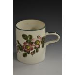 A Wemyss cylindrical mug, painted with wild roses, banded green borders, loop handle, 14cm high,