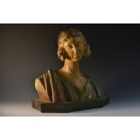 An Art Nouveau French plaster bust, head and shoulders, of a lady, wearing a head piece,