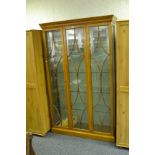 A contemporary mahogany glazed cabinet, ogee cornice, astral glazed panelled doors,