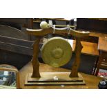 An early/mid 20th Century oak gong embossed sunflower drum