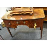 An Edwardian mahogany bow fronted dressing table base, central short split frame,
