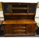 A mid 20th century,oak, Old Charm dresser, astral glazed cupboard doors, projecting base,