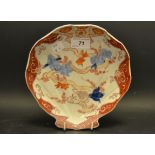 An Oriental shell shaped dish painted in the Imari palette with Carp swimming amongst fronds