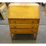 An early 20th century light oak bureau,