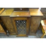 A late 20th Century side by side cabinet astral glazed doors