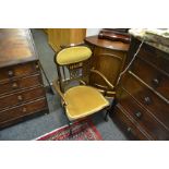 An Edwardian mahogany open armchair, upholstered and scrolling back, shaped arms,