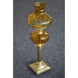 A Victorian brass Corinthian column oil lamp, amber glass reservoir and shade, twin burner,