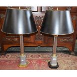 A pair of table lamps, brass capitals, tubular steel columns, canted square plinth,