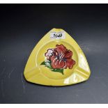 A Moorcroft Hibiscus pattern triangular ashtray,