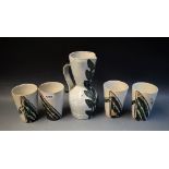 A Vallauris stoneware lemonade set for four comprising pitcher and tumblers decorated with abstract