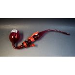 A Victorian cranberry glass pipe