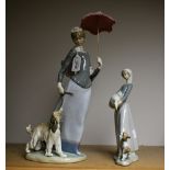 Lladro - a figure of a wind swept girl with parasol walking her hound,