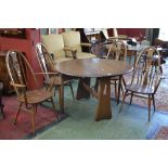 An Ercol Golden Dawn Windsor dopleaf table and four chairs including two cravers.