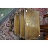 A nest of three oak occasional tables