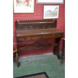 An Aesthetic movement serving table, carved gallery, single drawer to frieze, trestle style base.