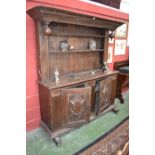 A 19th century German oak dresser, stepped cornice, shelves and under finials to top,