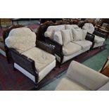 A Bergere three piece suite comprising two seat settee and two armchairs.