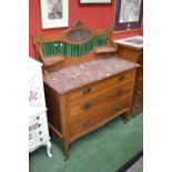 An oak Art Nouveau washstand, tile back, rouge marble top, three graduated drawers to base,