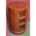 A large yew circular revolving bookcase