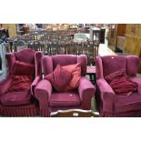 Three wing back armchairs,