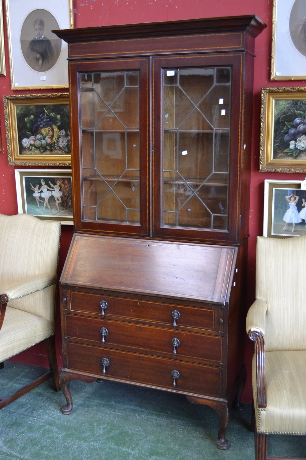 An Edwardian mahogany bureau bookcase, ogee cornice over two led glazed doors to top,