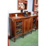 A reproduction George III style mahogany breakfront cabinet, galleried back, gadrooned border,