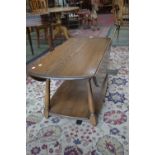 An Ercol dropleaf coffee table, oval top, spreading legs, undertier.