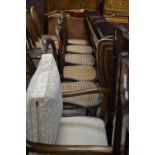 A wicker-worked open arm club chair; two Victorian mahogany balloon back bedroom chairs;