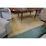 A large hand knotted rug in hues of mustard, taupe and sienna. 335cm x 250cm approximately.