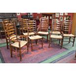 A set of eight French country ladderback dining chairs including two carvers, raffia seats,