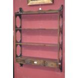 A Bevan Funnell mahogany four tier wall shelf, serpentine shelving,