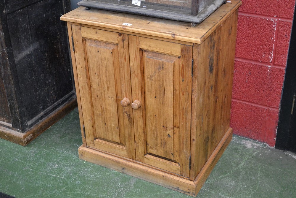 A vintage style pine two door cupboard with storage and pigeonholes to the interior.