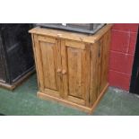 A vintage style pine two door cupboard with storage and pigeonholes to the interior.