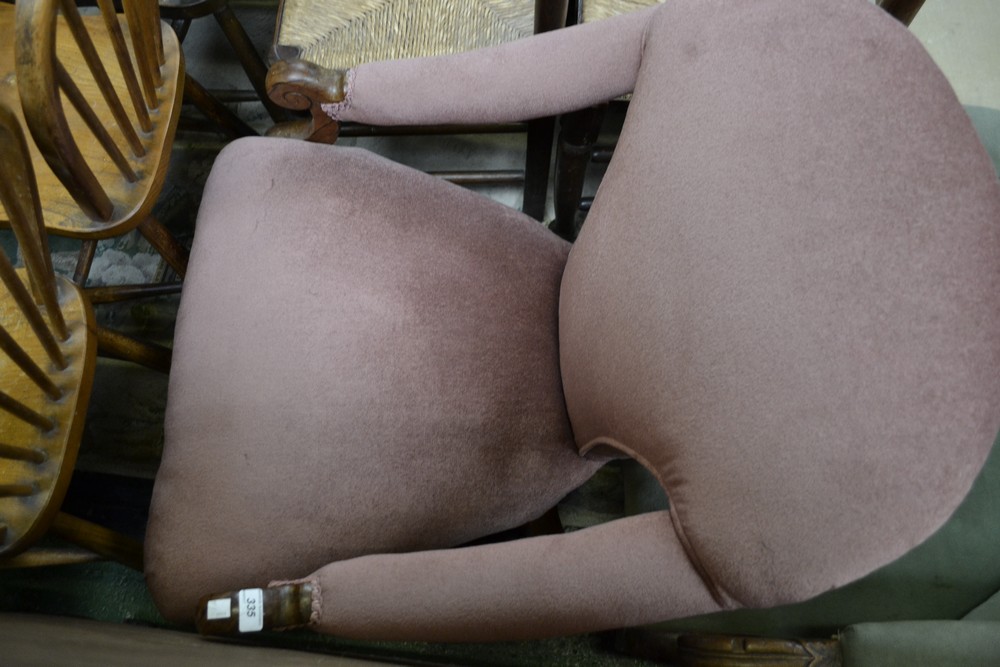A Victorian rosewood salon armchair, padded back, down swept open arms,