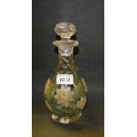 An early 20th century ovoid decanter, boldly painted with water lily flowers and leaves,