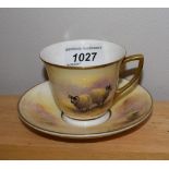 A Milwyn Holloway cup and saucer, hand painted with sheep,