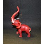 A Goebel model, Red Elephant with trunk erect,