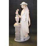 A mid 20th century Lladro figure of an elegant lady with flowers,