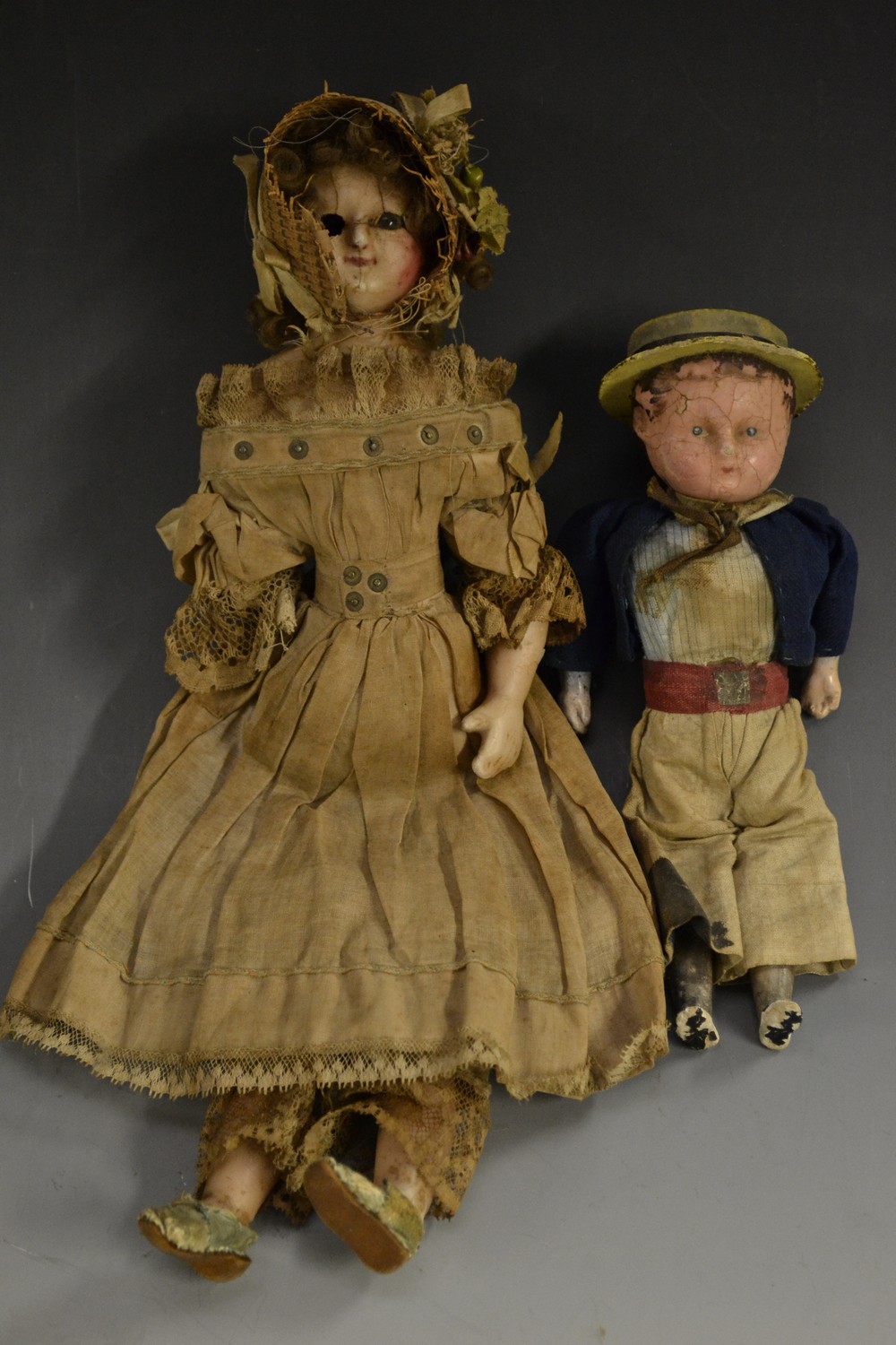 Dolls - a mid 19ct century wax headed and limbed doll, of a girl, in lace trimmed period costume,