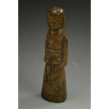 A Germanic carved fruit wood doll, possibly 17th century, as a female with over lapping arms,