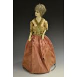 A 19th century wax headed doll, of a standing lady, cast head and torso, facing at an slopped angle,