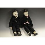 A pair of porcelain headed character dolls, Laurel and Hardy, cloth bodies,