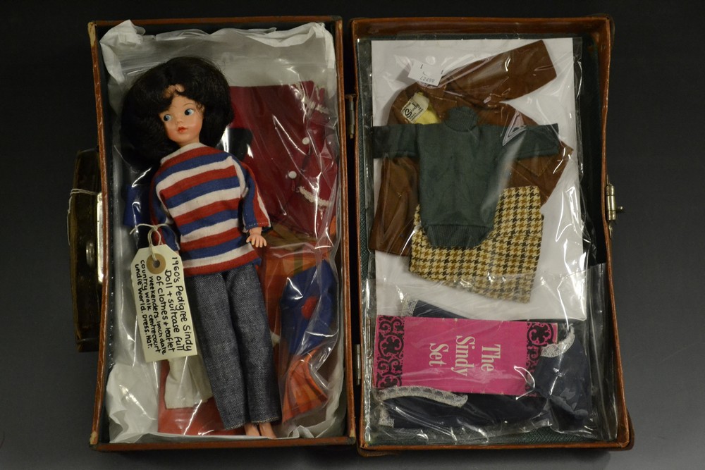 A 1960s Pedigree Sindy doll, brunette hair, assorted clothes and accessories including Weekenders,